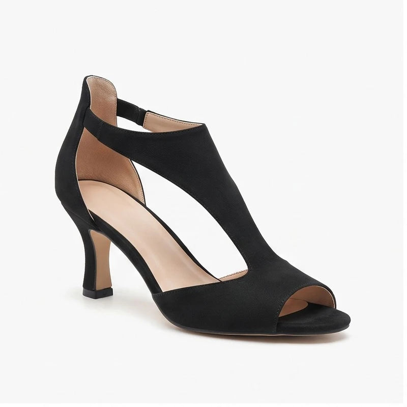 Black suede heels on a white background