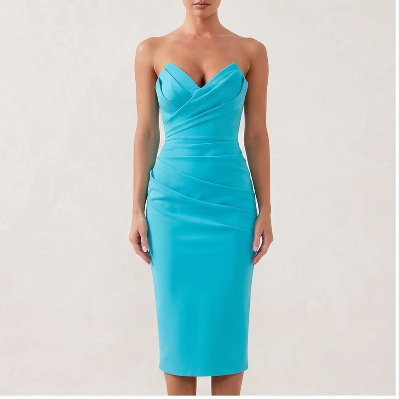 Model wearing Turqoise dress in a studio
