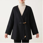 Model wearing Black coat in a studio