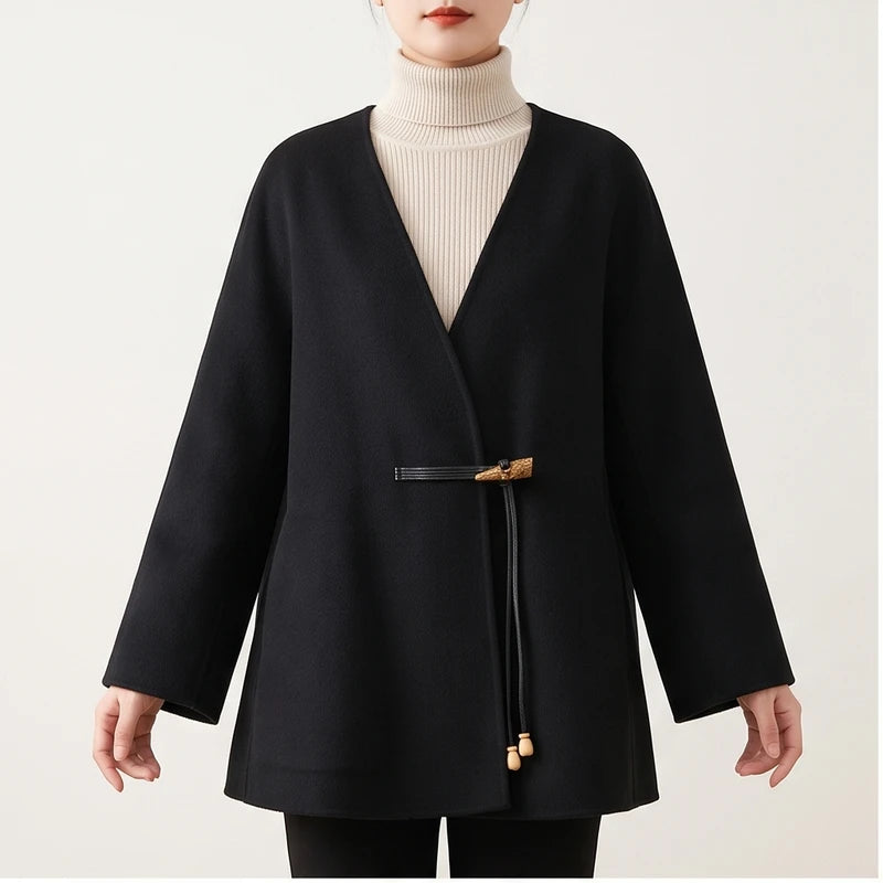 Model wearing Black coat in a studio