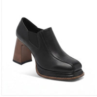 Black leather heels on a white background