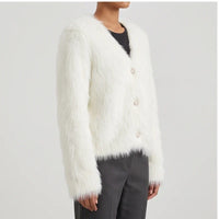 Model wearing white thicken knitted cardigan in a studio - 2
