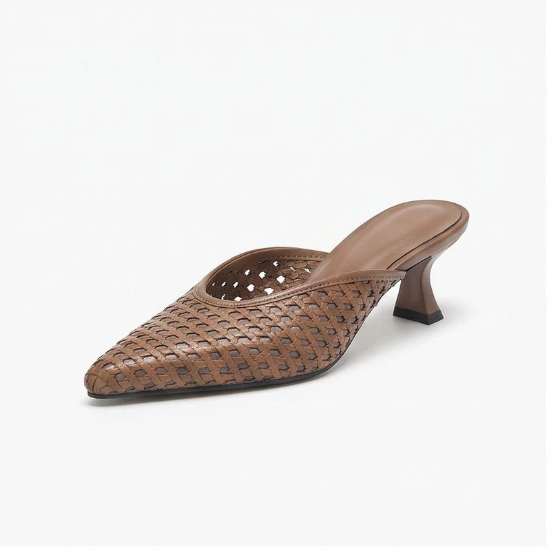 Brown leather mules on a white background