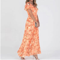 Model wearing Orange chiffon dress in a studio