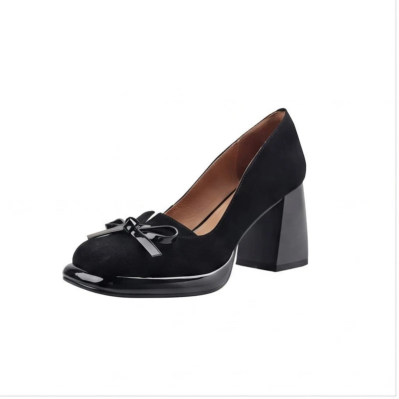 Black suede heel on a white background