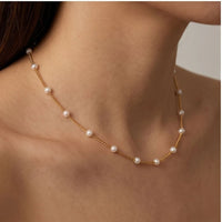 Model wearing Celestine Gold Pearl Necklace Celestine Gold Pearl Necklace close-up - 3