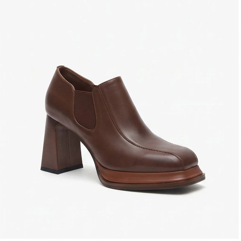 Brown leather heels on a white background