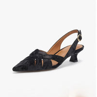 Black leather heels on a white background