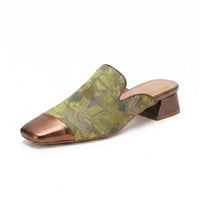 Green mules on a white background