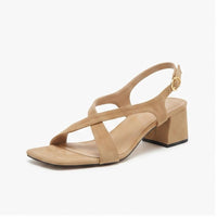 Beige suede sandals on a white background