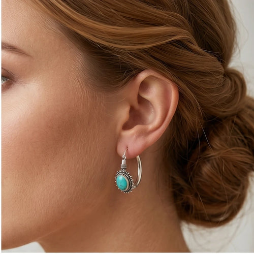 Model wearing Calypso Turquoise Sterling Hoop Earrings Calypso Turquoise Sterling Hoop Earrings close-up - 2