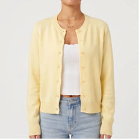 Model wearing S knit cardigan in a studio